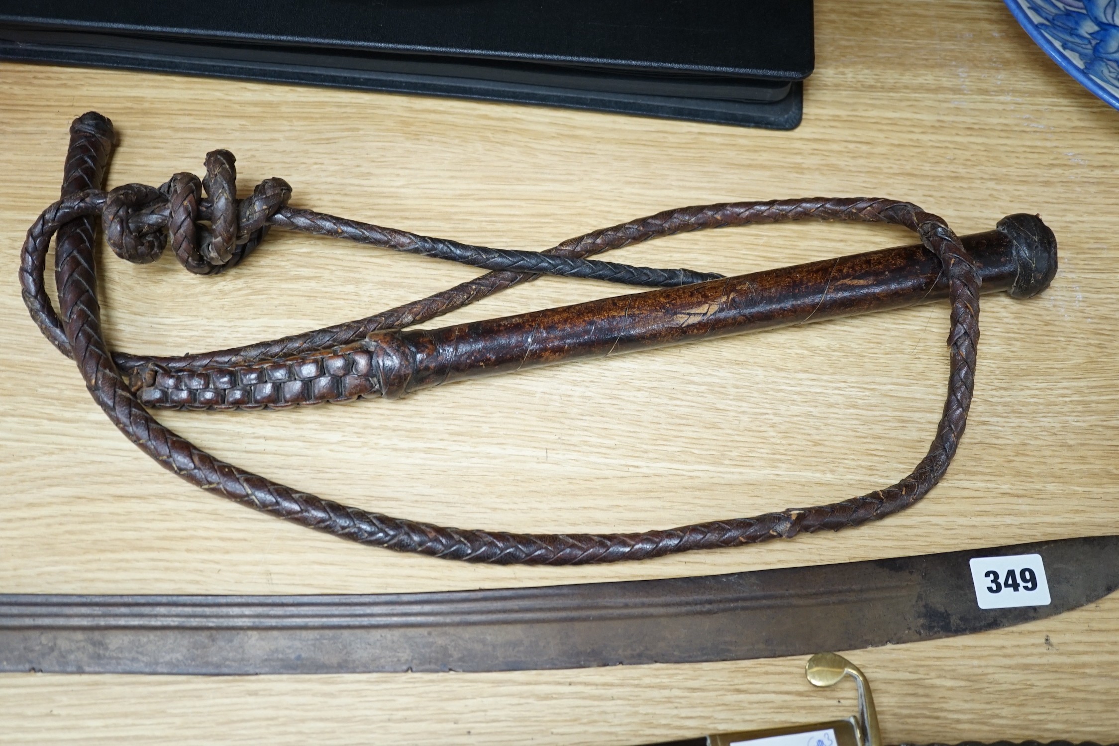 An Ottoman tulwar sabre, a European sabre and a leather whip
